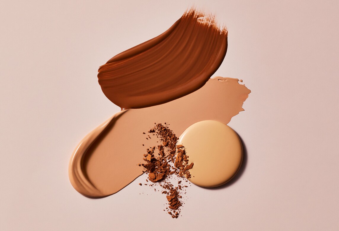 different estee lauder foundation textures on a smooth beige surface