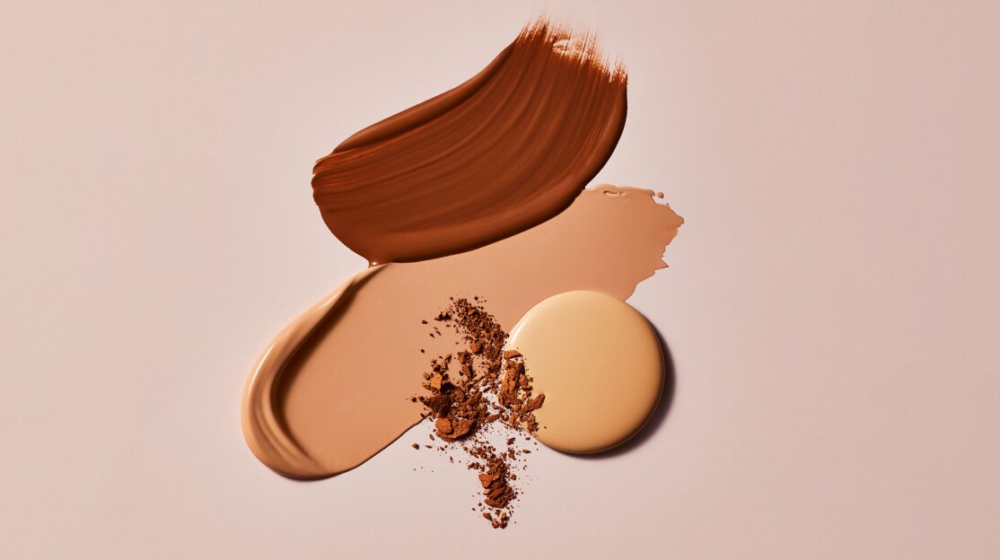 different estee lauder foundation textures on a smooth beige surface